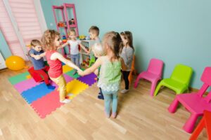 cheerful preschool kids standing circle holding each other s hands games teach cooperation team building lovely children room with colorful furniture copia copia
