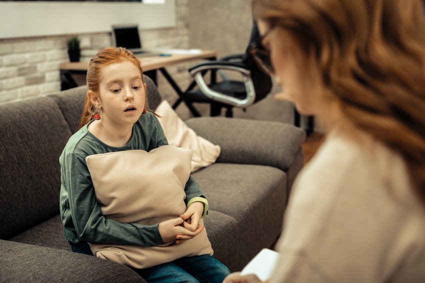 childhood problems sad cheerless girl speaking about her difficulties life while having session with psychologist copia 2