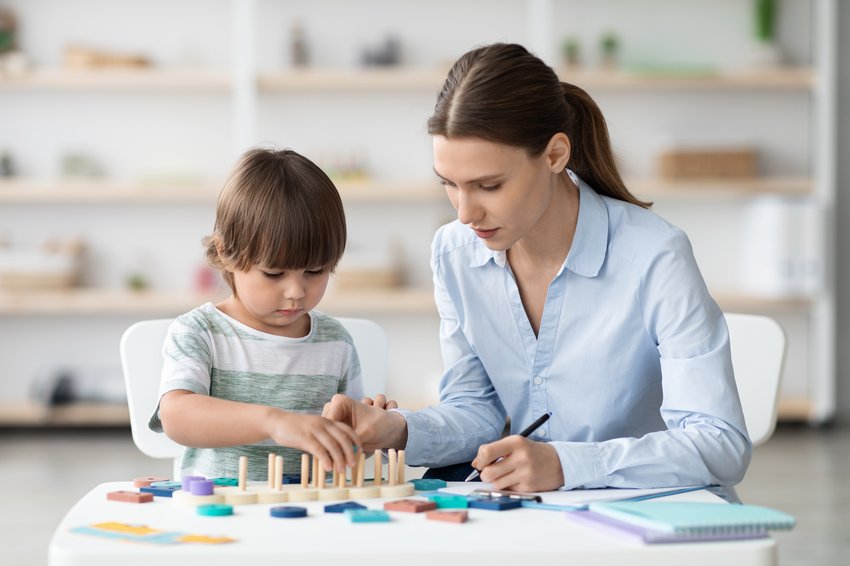 cute little boy playing logical game specialist cabinet woman psychologist making notes office copia 2