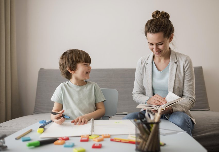 front view child being tutored home by woman copia
